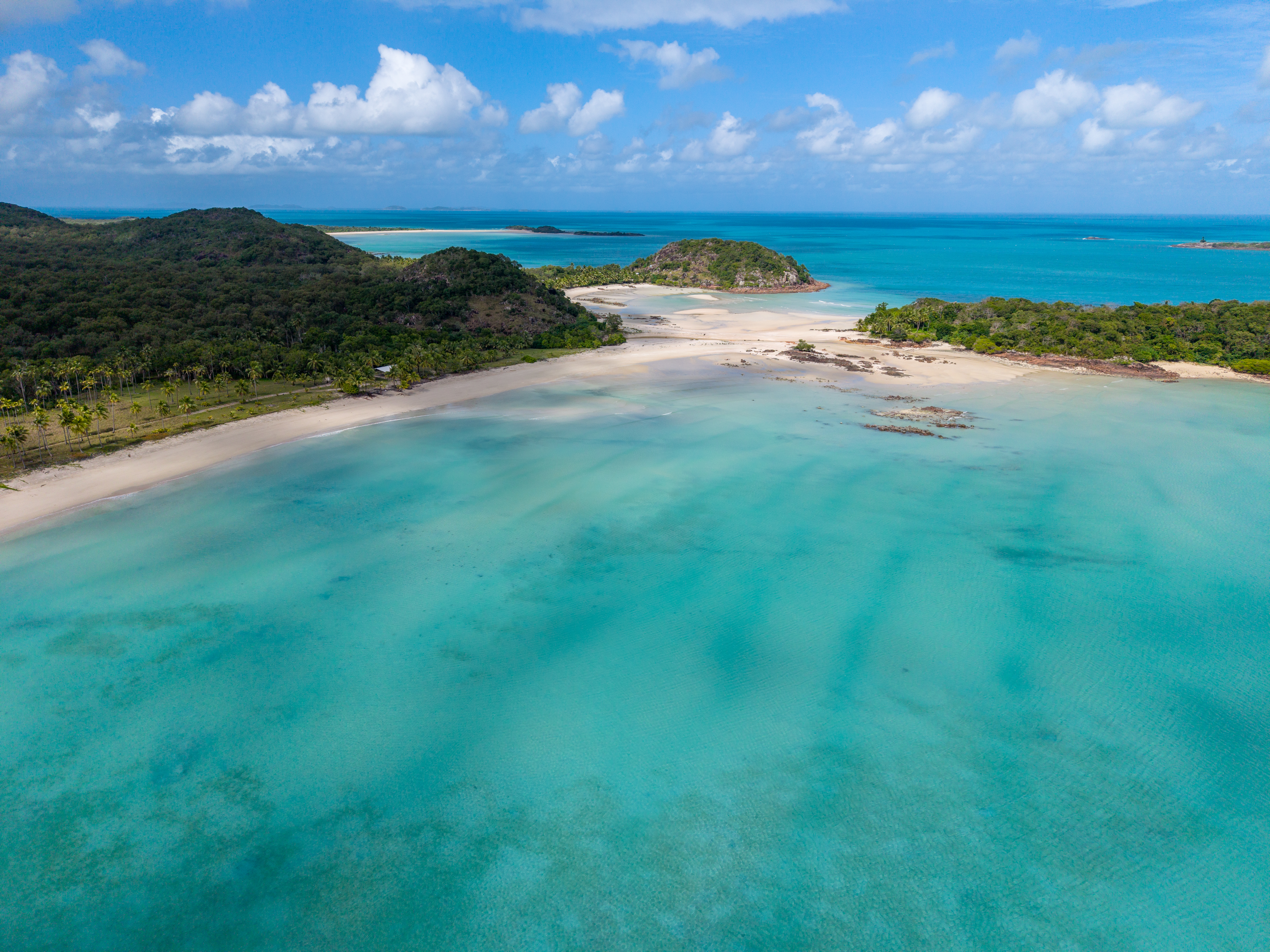 Remote tropical coastline and clear turquoise water from above
