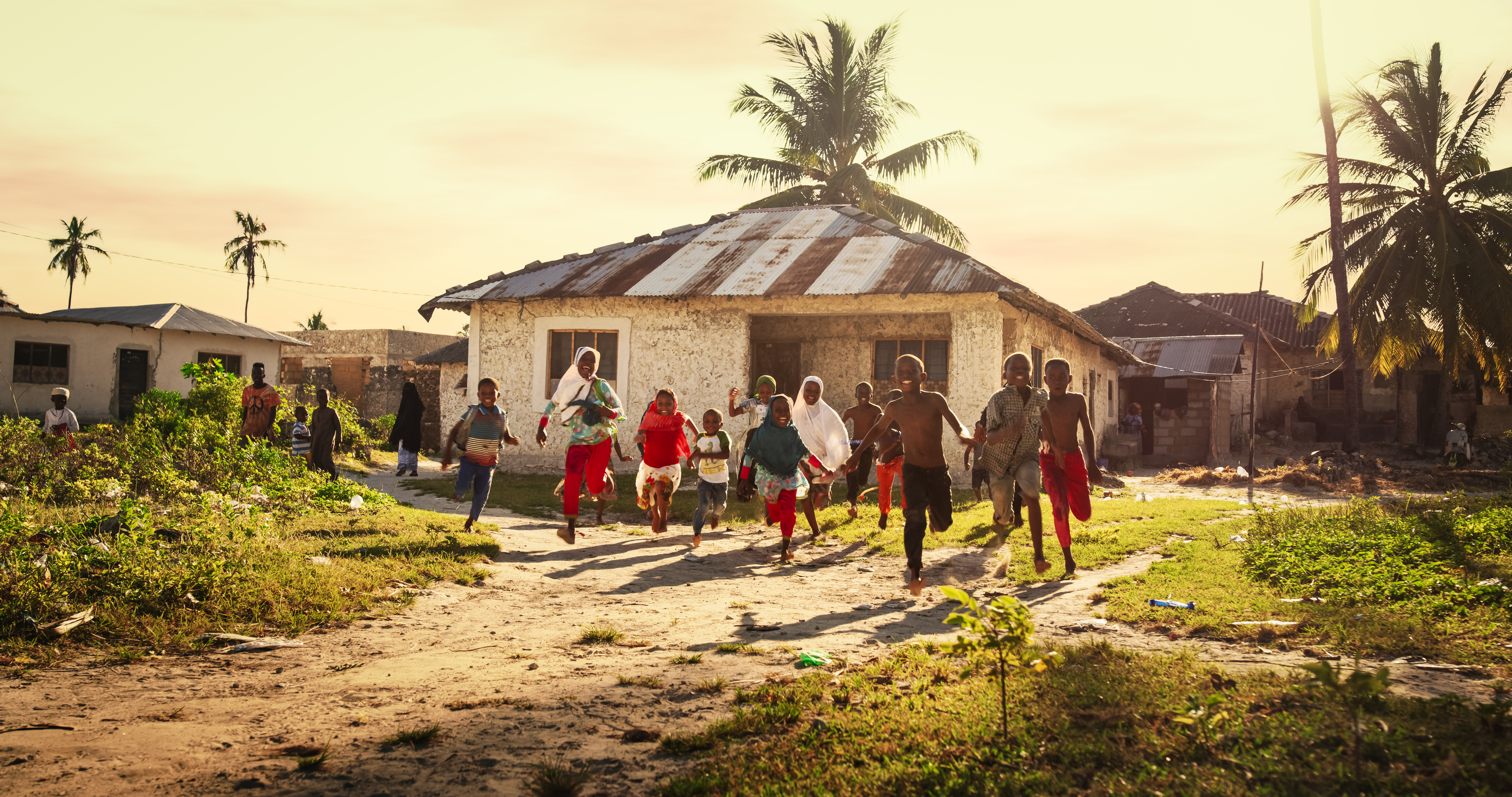 Children running happily through a rural community