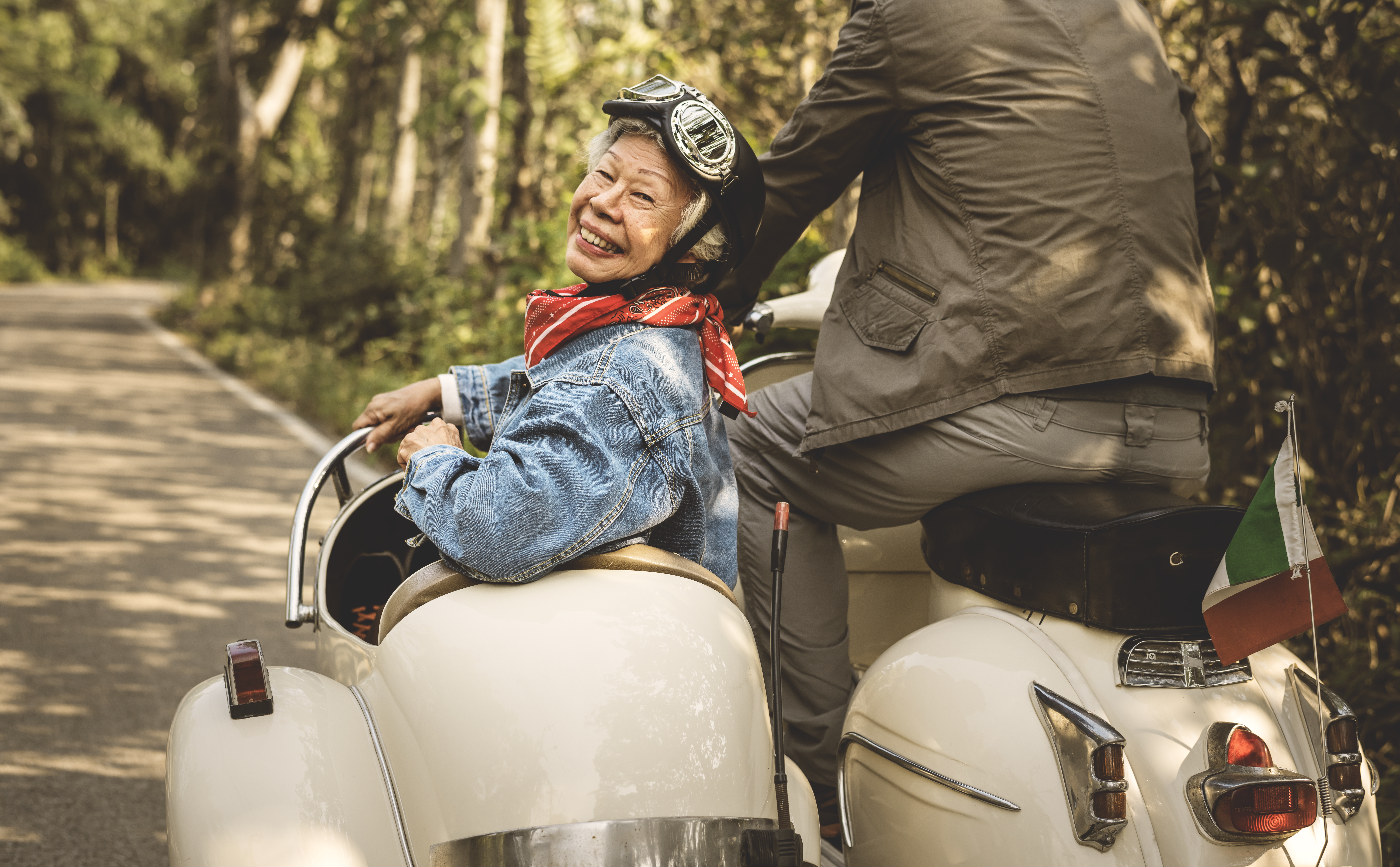 Older woman smiling from the sidecar of a motorcycle