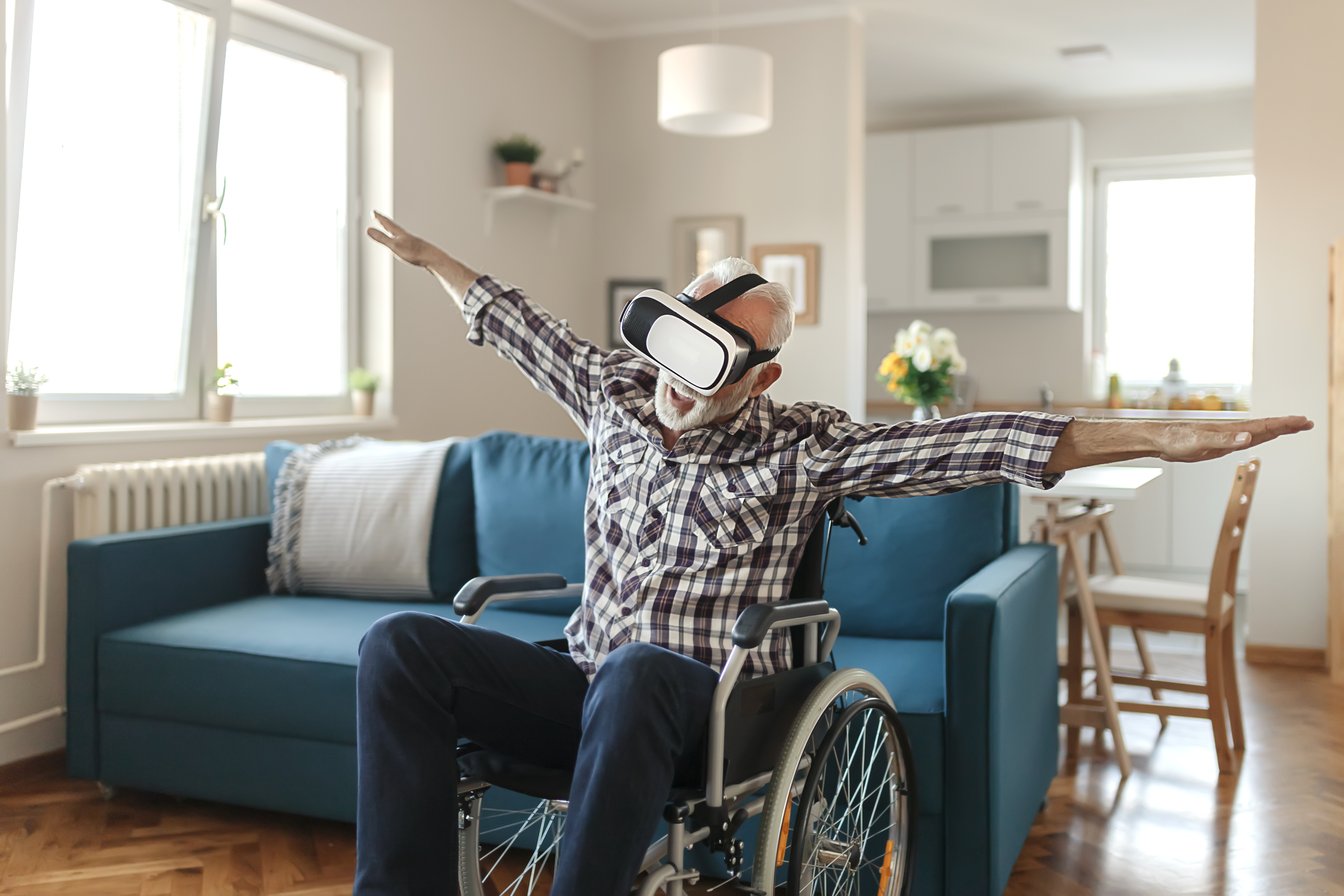 Senior man in a wheelchair wearing virtual reality goggles
