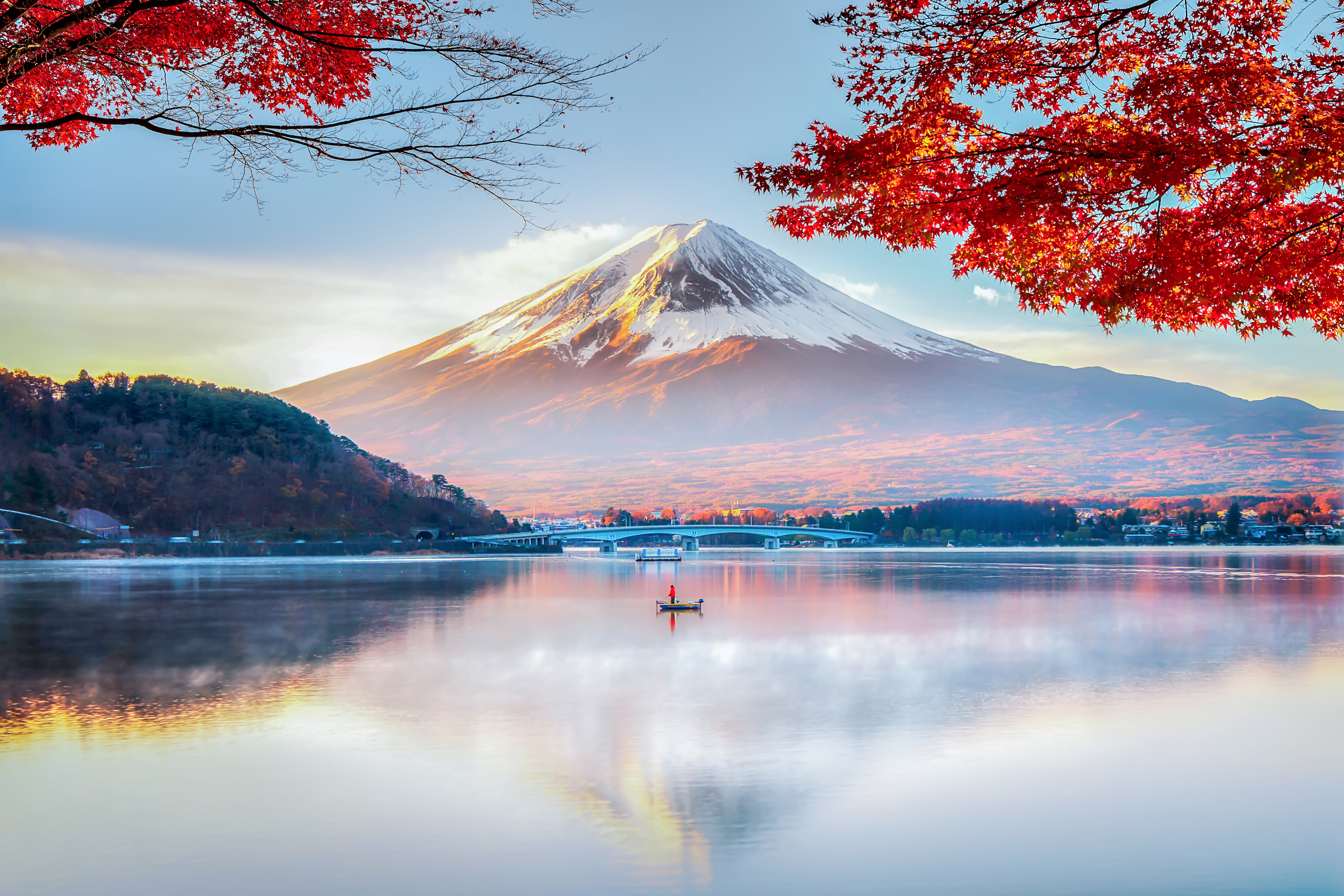 Mount Fuji rising over a calm Japanese landscape