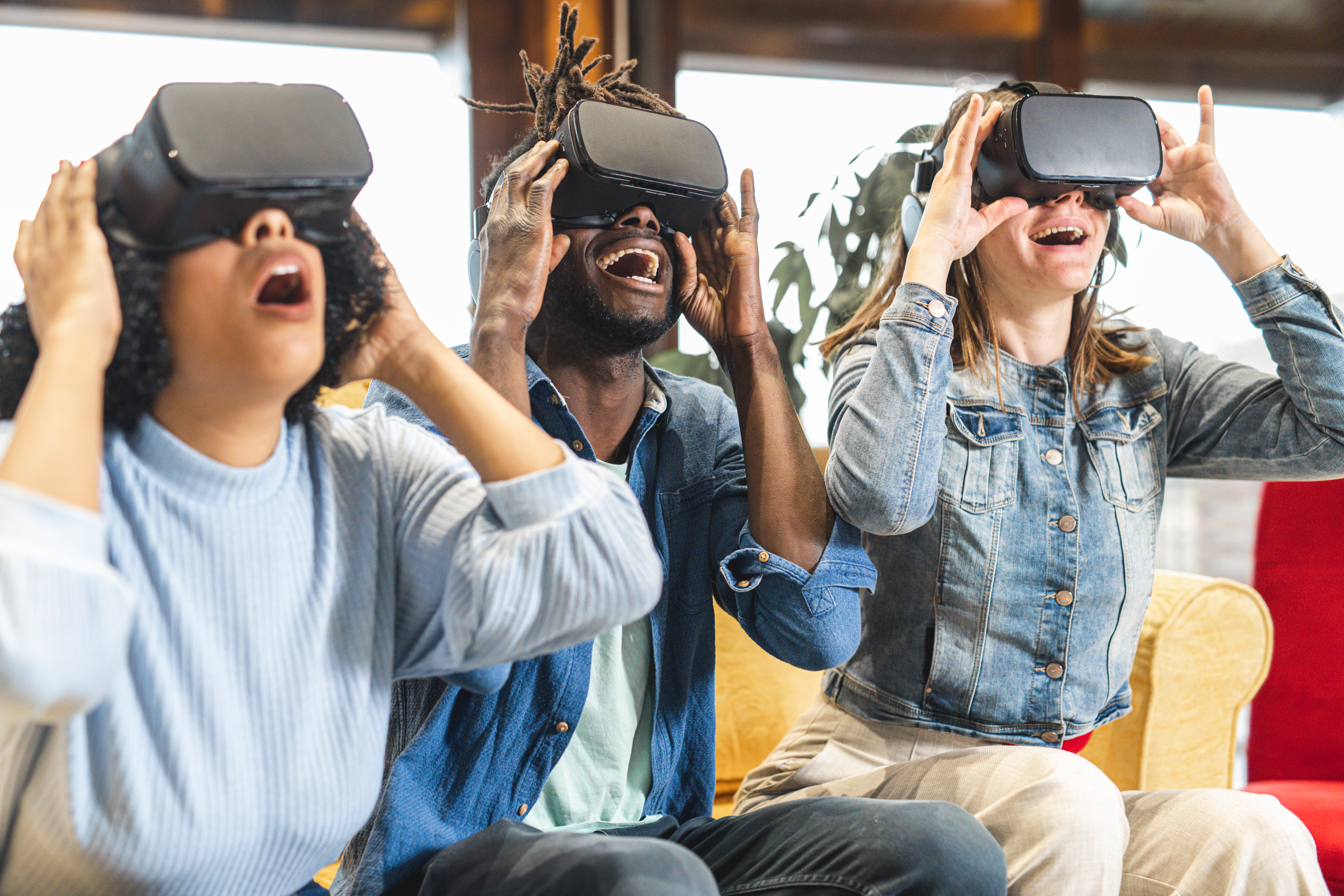Three people sharing a VR travel experience together