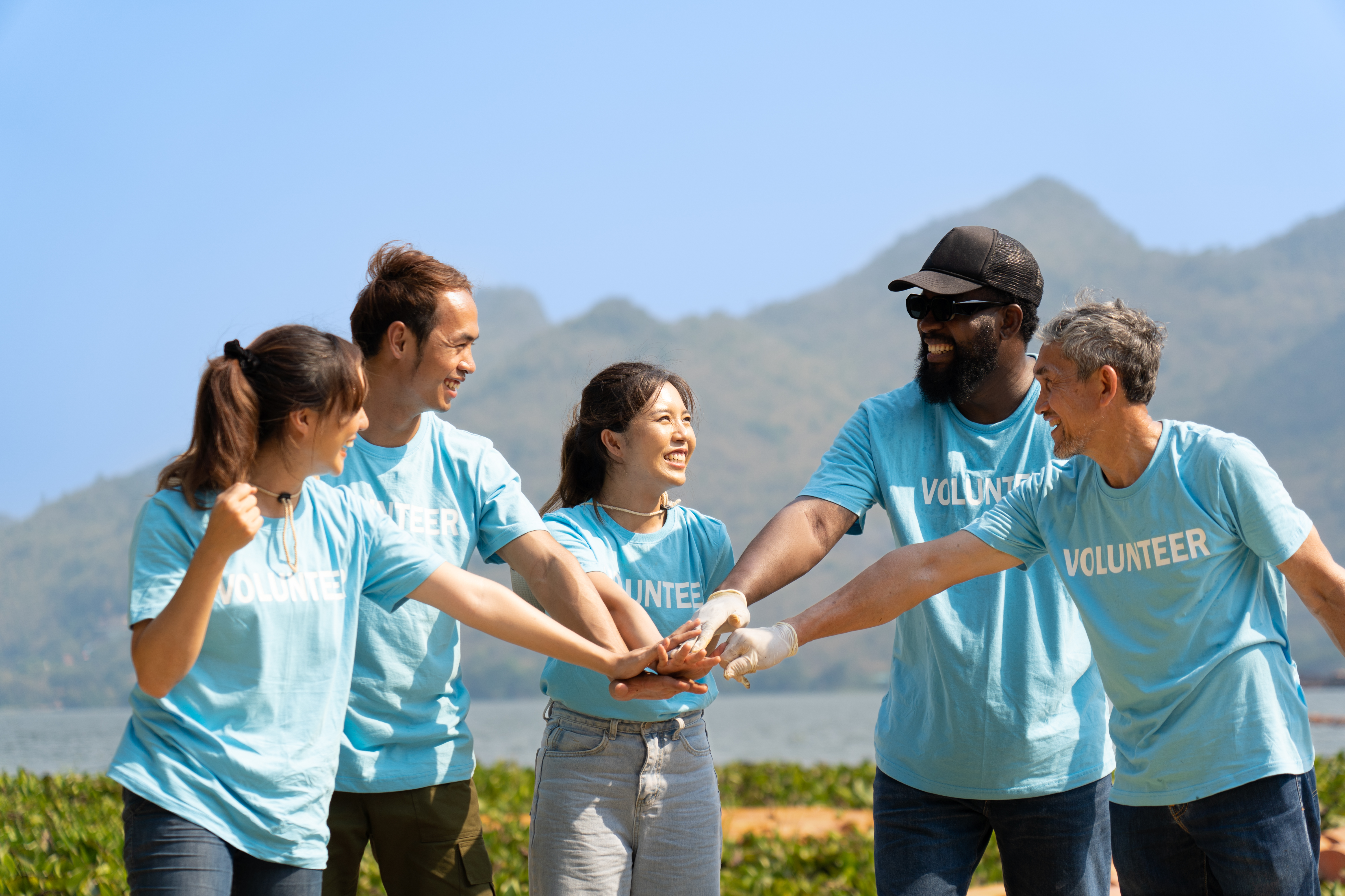 Volunteers joining hands before community work