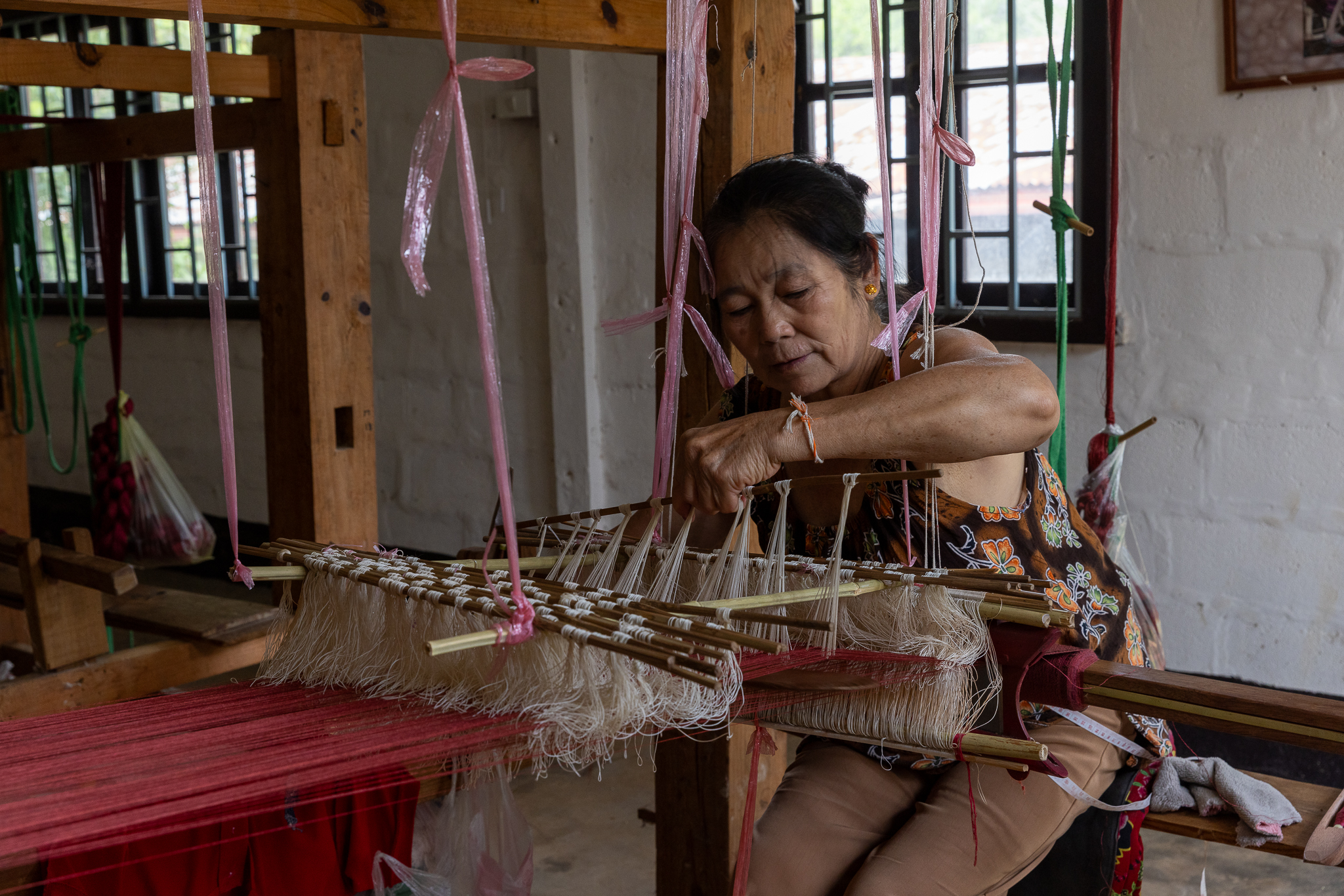 Woman in Laos weaving silk on a traditional loom